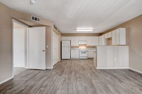 Las Vegas apartment for rent - A kitchen with white cabinets and a white fridge.