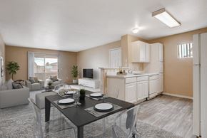 Las Vegas apartment for rent - A modern dining room with a glass table and chairs.