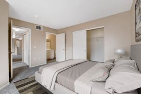 Las Vegas apartment for rent - A bedroom with a large bed and a carpeted floor.