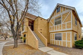 Las Vegas apartment for rent - A house with a brown and tan exterior and a staircase leading to the front door.