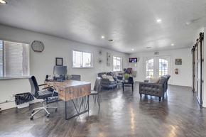 Las Vegas apartment for rent - A spacious room with a wooden table and chairs.