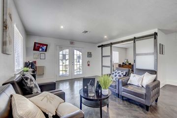 Las Vegas apartment for rent - A modern living room with a grey couch and a coffee table.
