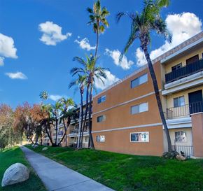Valley Village apartment for rent - A building with a balcony and a palm tree in front of it.