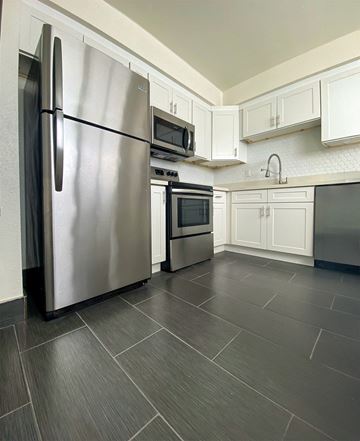 Valley Village apartment for rent - A modern kitchen with a stainless steel refrigerator and microwave.
