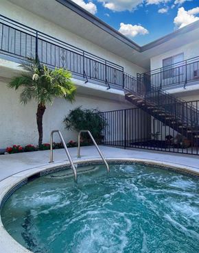 Encino apartment for rent - A hot tub sits in the middle of a patio with a staircase and a balcony in the background.