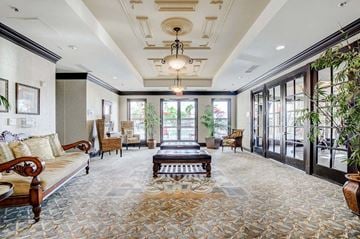 Las Vegas apartment for rent - A large, well-furnished living room with a patterned carpet and a chandelier.