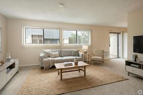 Costa Mesa apartment for rent - A living room with a grey couch, a coffee table, and a flat screen TV.