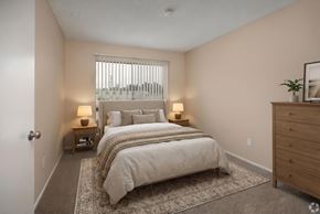Costa Mesa apartment for rent - A bedroom with a large bed and two lamps.
