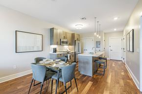 Westbury apartment for rent - A modern kitchen with a dining table set for four.