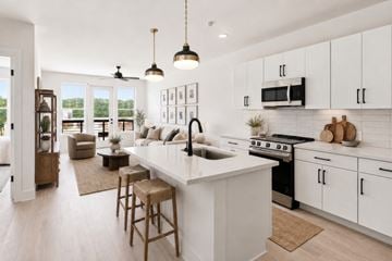 Chapel Hill apartment for rent - A modern kitchen with white cabinets and a large island.
