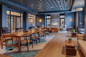 Westbury apartment for rent - A modern dining room with a long wooden table and chairs.
