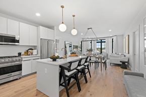 Westbury apartment for rent - A modern kitchen with a dining table and chairs.