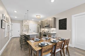 Westbury apartment for rent - A modern kitchen with a dining table set for four.