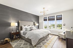 Westbury apartment for rent - A bedroom with a large bed and a window with blinds.