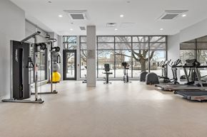 Ottawa apartment for rent - A gym with a variety of equipment including treadmills, weights, and exercise machines.