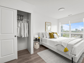 Waterloo apartment for rent - A bedroom with a large bed and a view of the city.