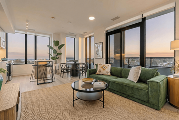 Hamilton apartment for rent - A living room with a green couch and a view of the ocean.