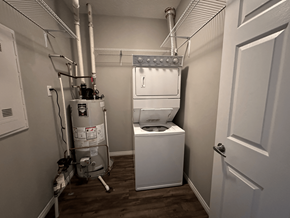 Spruce Grove apartment for rent - A small, white bathroom with a toilet and a water heater.