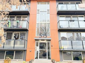 Calgary apartment for rent - A modern building with a glass entrance and balconies.