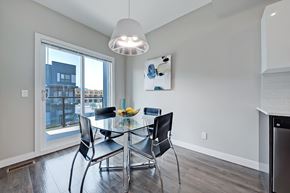Calgary apartment for rent - A modern dining room with a glass table and chairs.