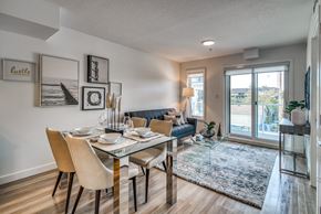 Calgary apartment for rent - A dining room with a glass table and chairs.