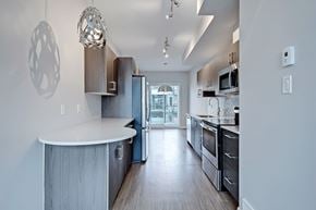 Calgary apartment for rent - A modern kitchen with a large island and stainless steel appliances.