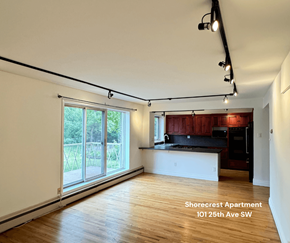 Calgary apartment for rent - A spacious apartment with a kitchen and a large window.
