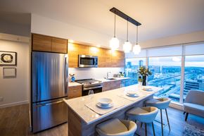 Calgary apartment for rent - A modern kitchen with a dining table and chairs.