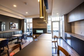 Calgary apartment for rent - A modern dining room with a long table and chairs.