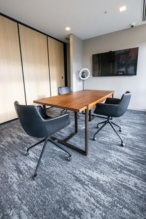 Calgary apartment for rent - A conference room with a wooden table and two chairs.