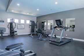 Beavercreek apartment for rent - A spacious gym with a variety of equipment including treadmills, weights, and exercise machines.
