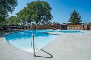 Dayton apartment for rent - A large outdoor swimming pool surrounded by trees.