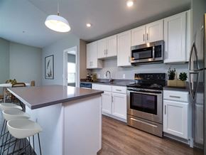 Dayton apartment for rent - a kitchen with white cabinets and stainless steel appliances