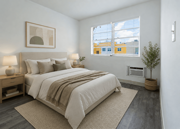 Miami apartment for rent - A bedroom with a large bed and a small tree.