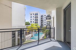 Fort Lauderdale apartment for rent - A balcony with a pool and a building in the background.