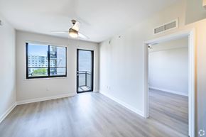 Fort Lauderdale apartment for rent - A spacious room with a ceiling fan and a view of the city.