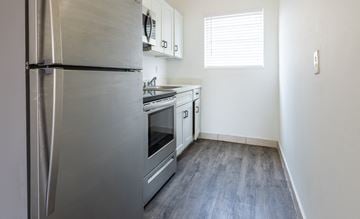Miami apartment for rent - A kitchen with a stainless steel refrigerator and oven.