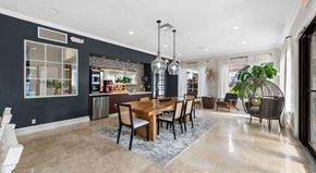 Miami apartment for rent - A dining room with a wooden table and chairs.