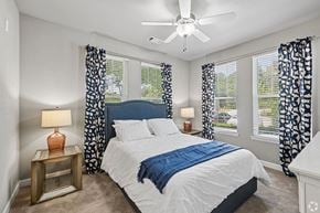 Fort Mill apartment for rent - A bedroom with a large bed and a ceiling fan.