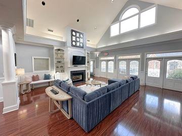 Raleigh apartment for rent - A living room with a blue couch and a fireplace.