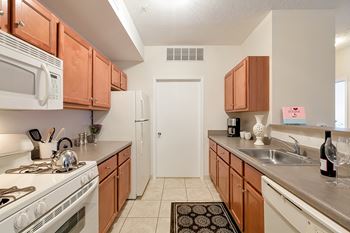Fully-equipped kitchens with gas ranges, dishwashers, and built-in microwaves