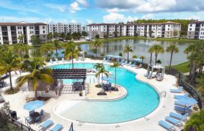 Naples apartment for rent - Beach-entry saltwater pool with sun shelves and cabanas overlooking private lake