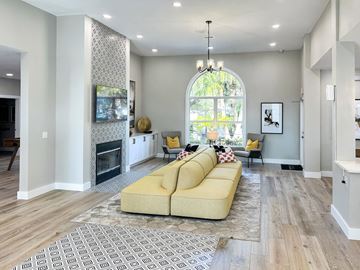 Tampa apartment for rent - A living room with a yellow couch and a fireplace.