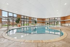 Willoughby Hills apartment for rent - A round indoor swimming pool with a glass barrier.