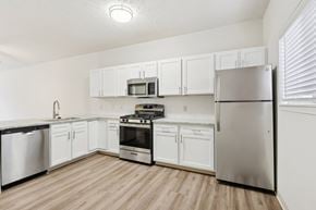 Willoughby Hills apartment for rent - A kitchen with white cabinets and stainless steel appliances.