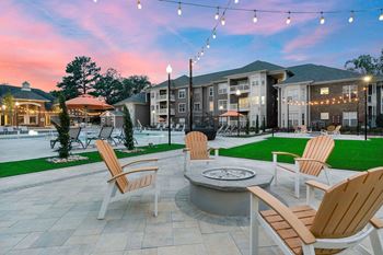 Outdoor lounge area with grills and fire pit