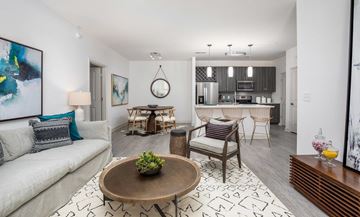 Mount Pleasant apartment for rent - A living room with a white couch, a coffee table, and a painting on the wall.