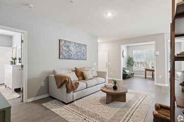 Tampa apartment for rent - A living room with a couch, a coffee table, and a painting on the wall.