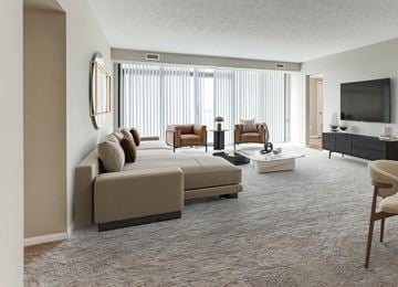 Beachwood apartment for rent - A living room with a large sectional sofa and a flat screen TV.