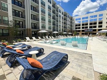 Heated knife-edge pool with sun shelves, cabanas, rain curtain, deck shower and water feature